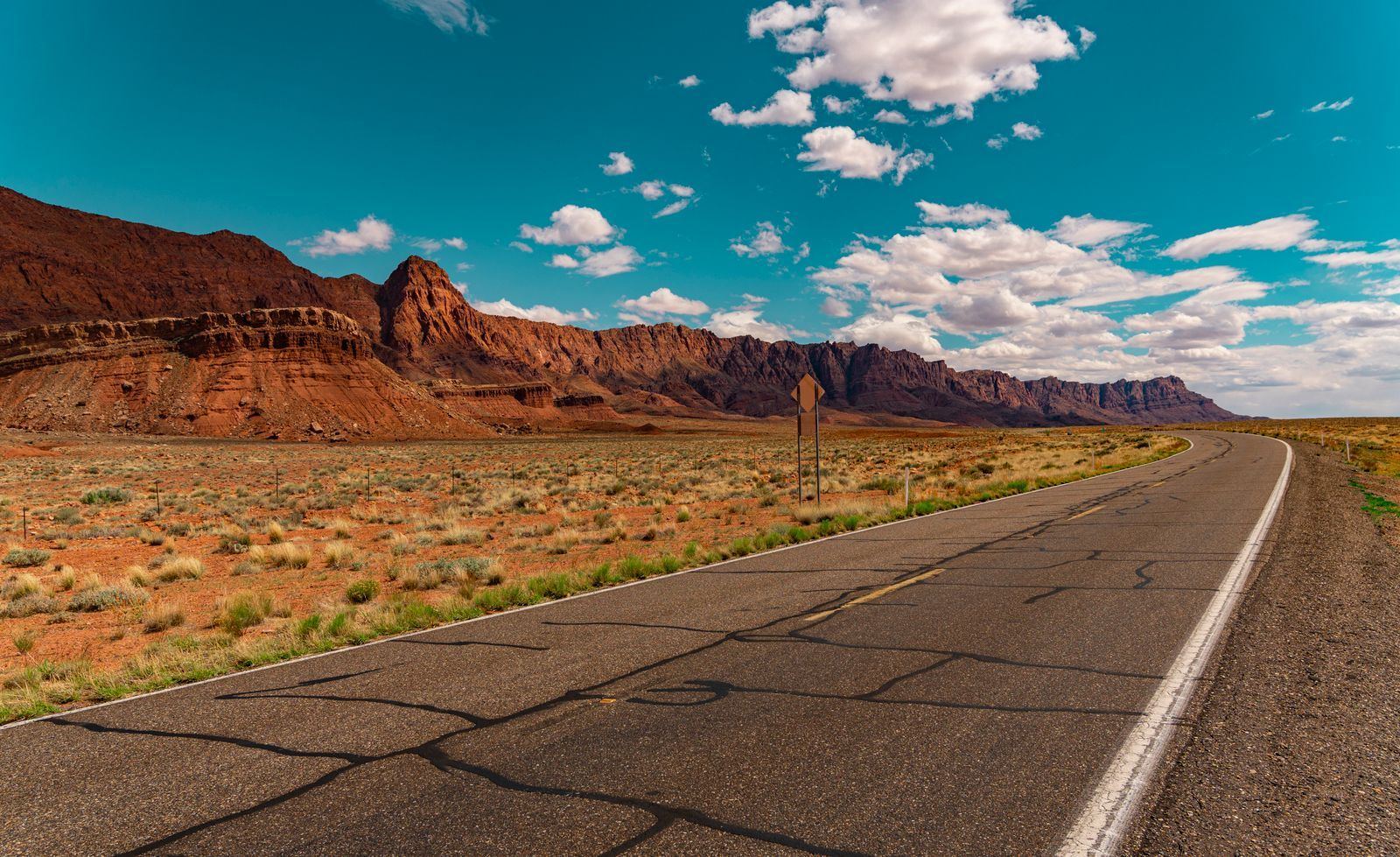 An Arizona desert highway stretching toward distant mountains