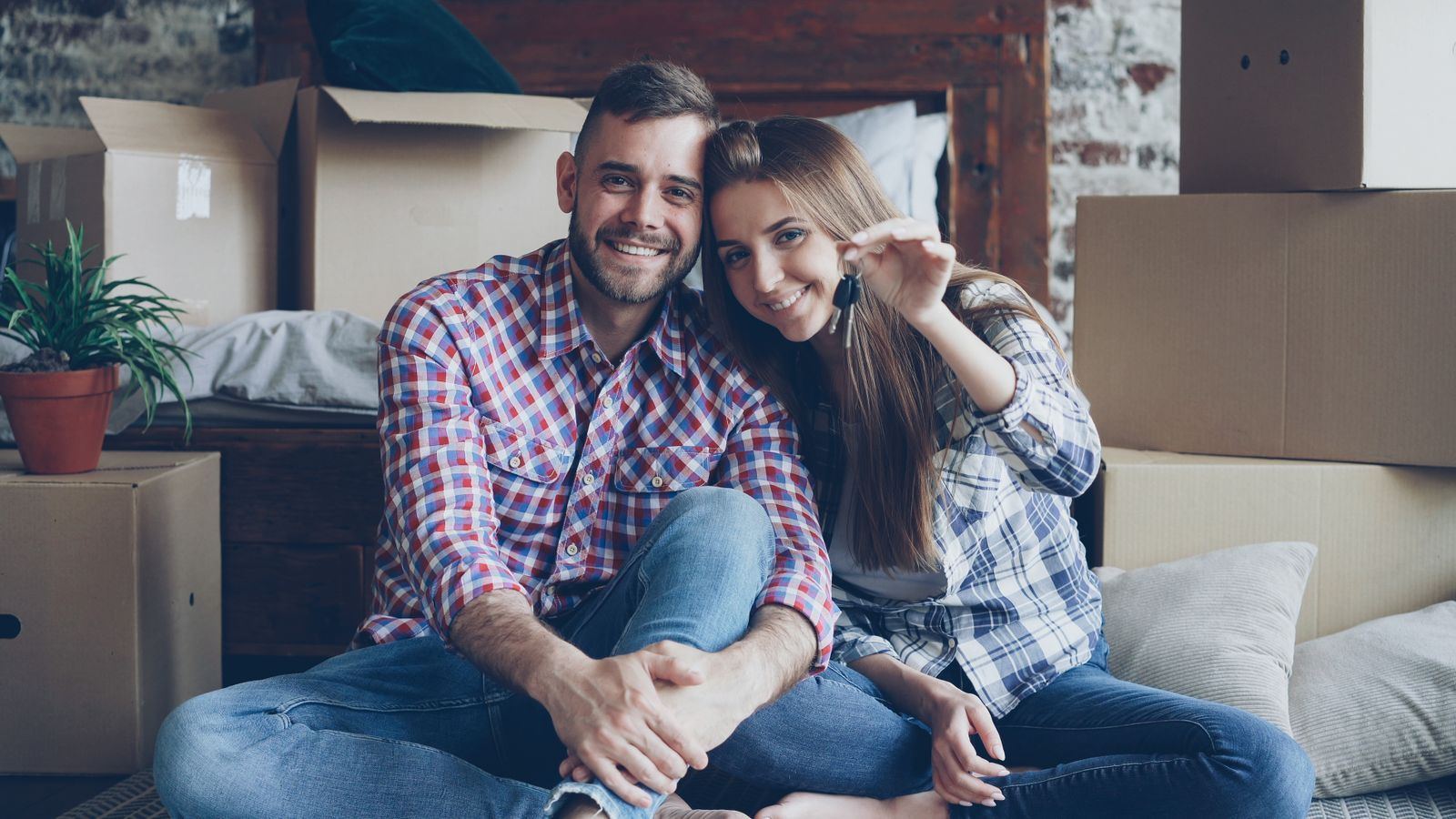A couple arriving at the front door of their first home